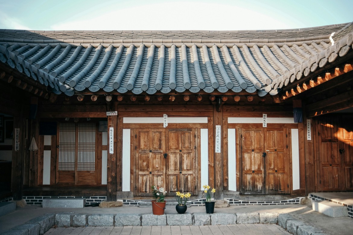 Traditional hanok courtyard with tiled roof and wooden doors showcasing classic Korean architecture